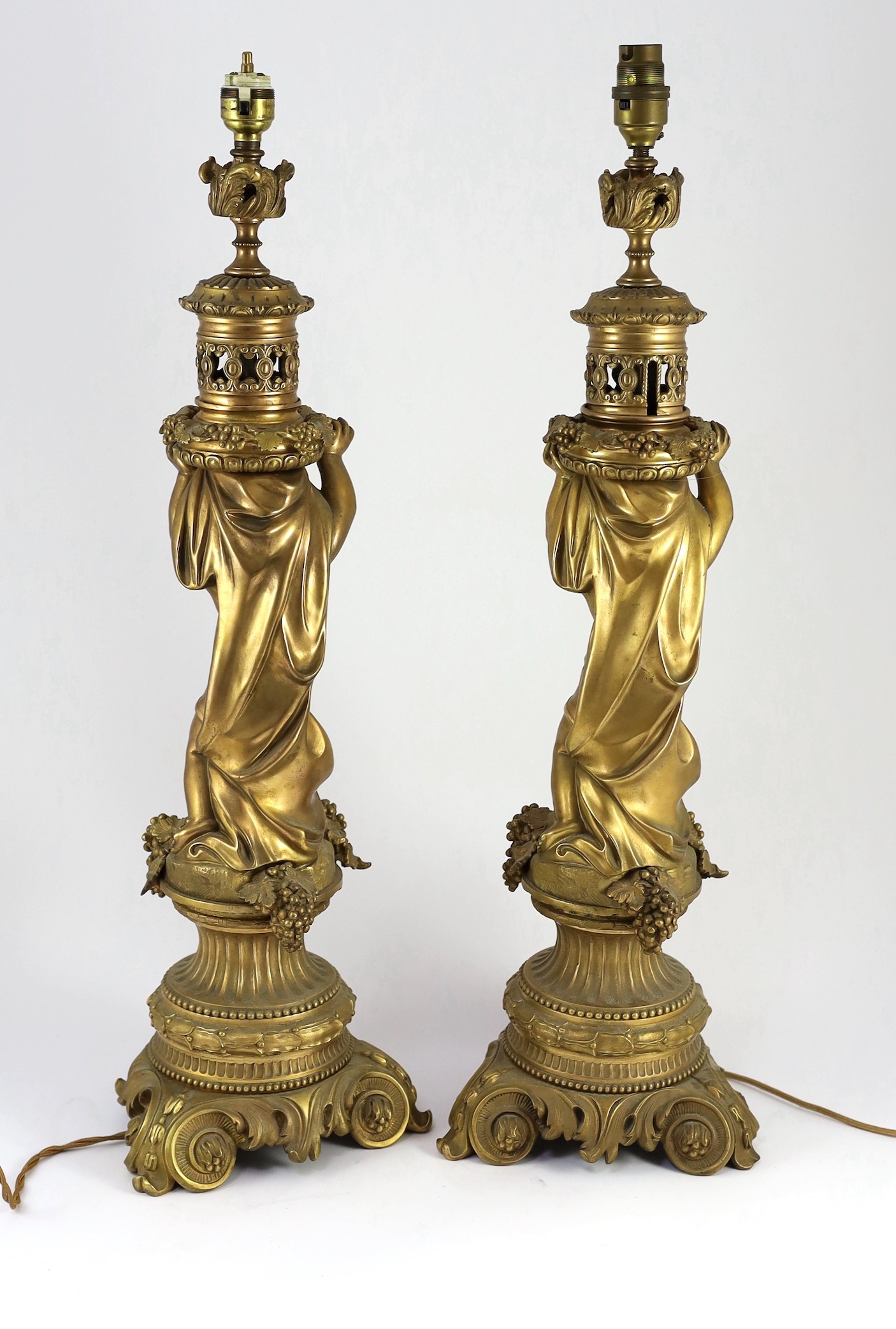 A pair of Victorian style ormolu table lamps, 50cm high to fittings